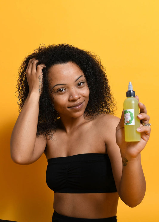 Person holding Hair Growth Oil